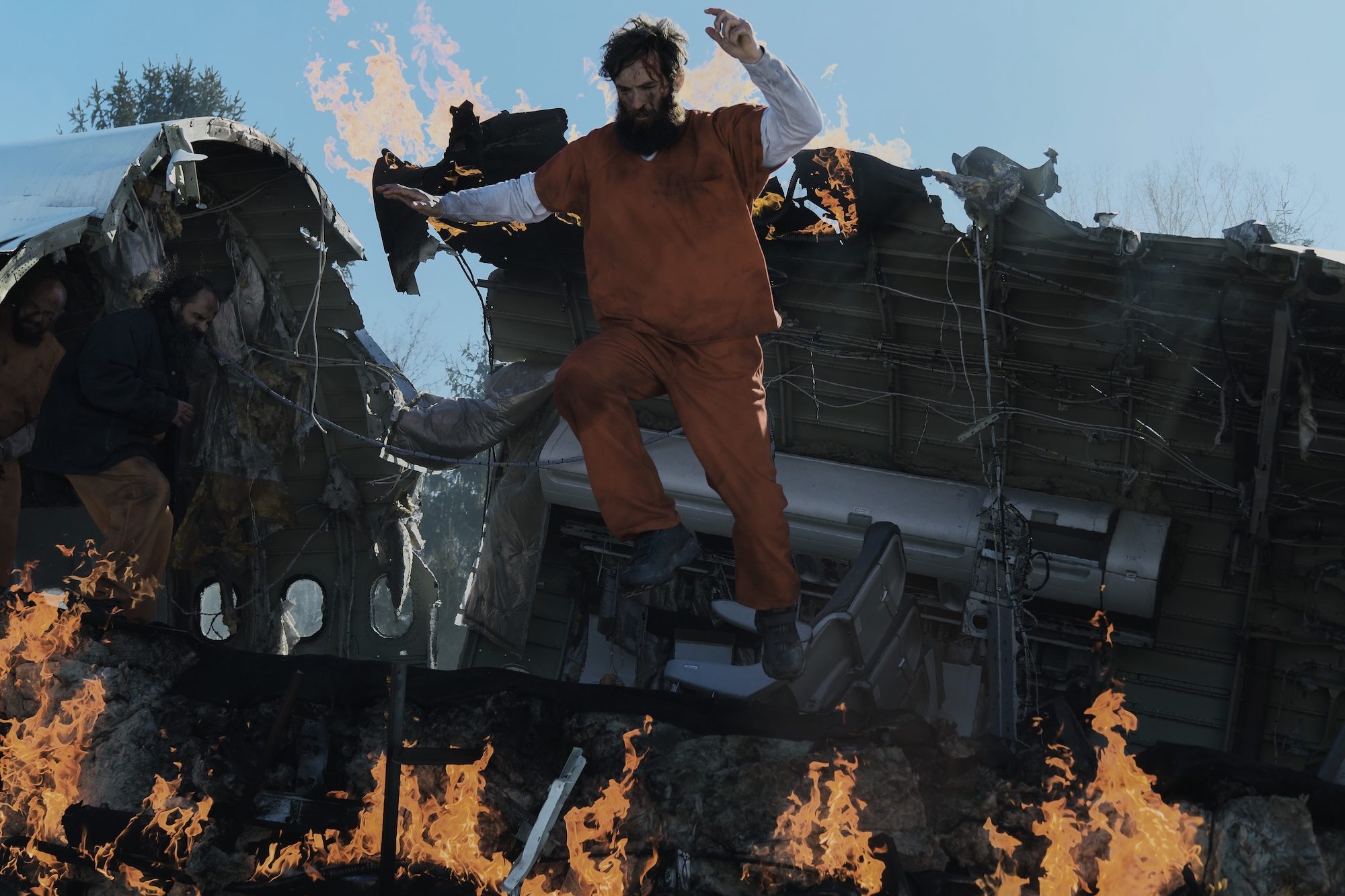 A man jumps out of a fiery plane.