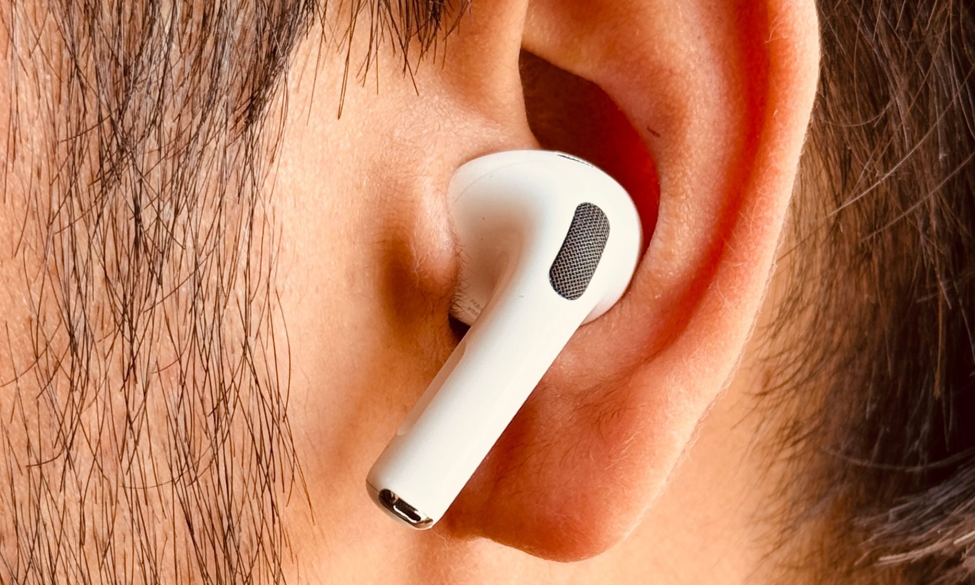 Person with Apple AirPods Pro 3 earbuds