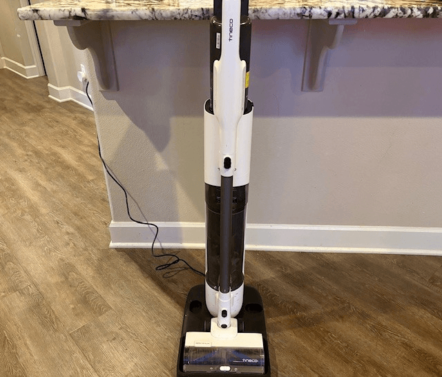 The Tineco Pure ONE Station FurFree on its charging dock in a modern kitchen