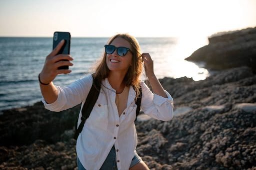 woman taking a selfie on the coast