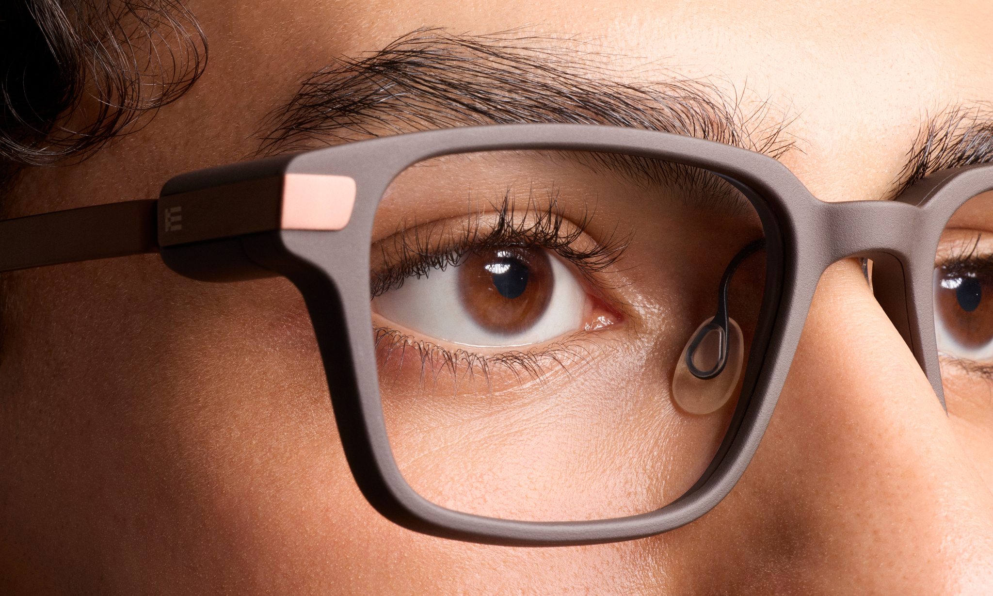 Close-up of one eye lens of the Even Realities G2 smart glasses, being worn by a woman