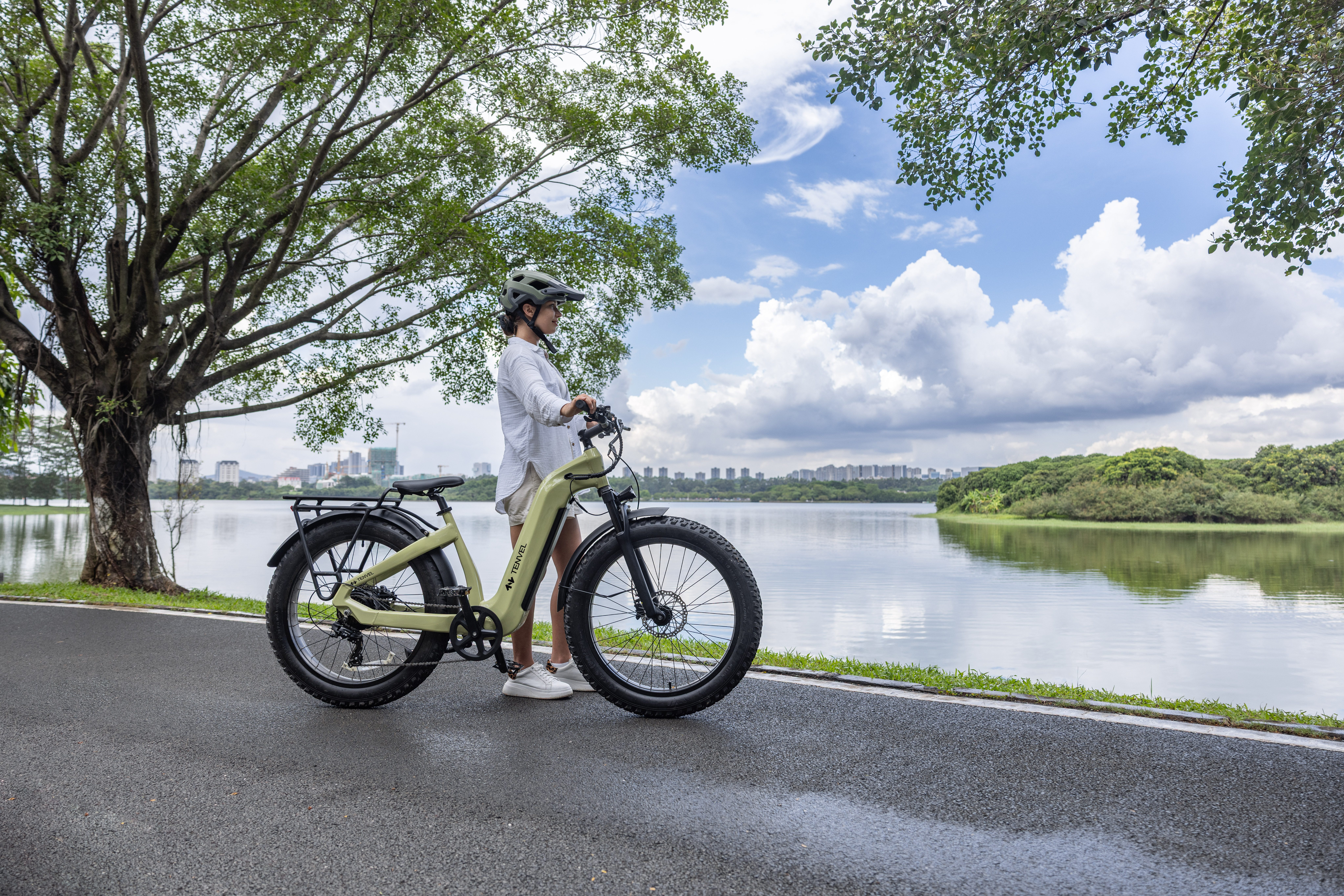 woman on bike overlooking body of water