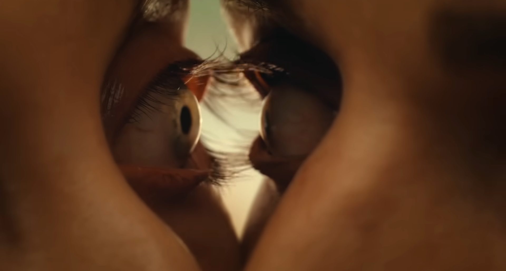 Alison Brie and Dave Franco's eyes about to fuse in the horror film Together.