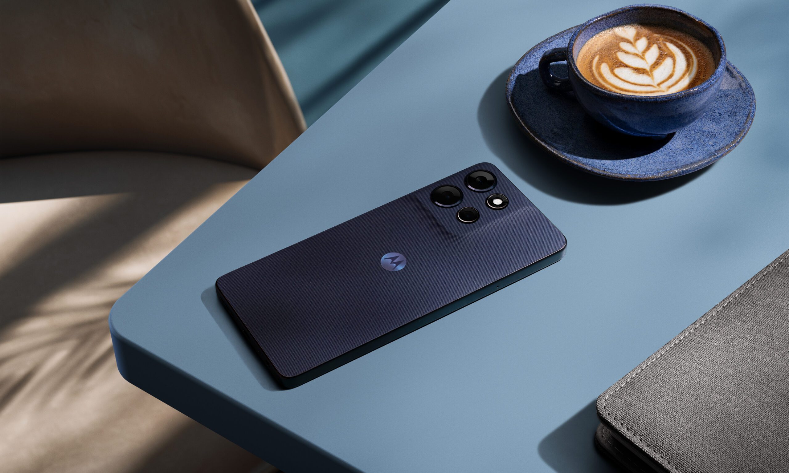moto g power 2026 on a table next to a coffee