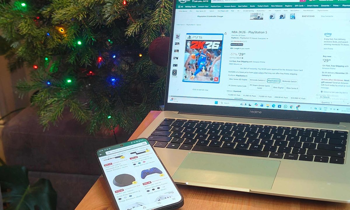An Android phone showing Amazon listings, next to a Realme laptop with a game listing, with a Christmas tree in the background.