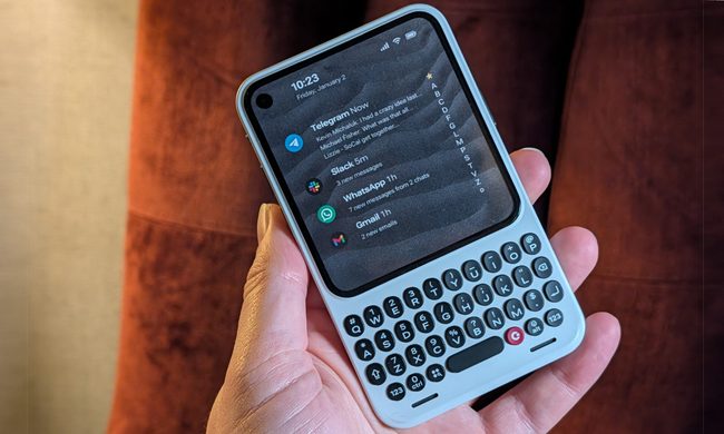 A hand holding the Clicks Communicator