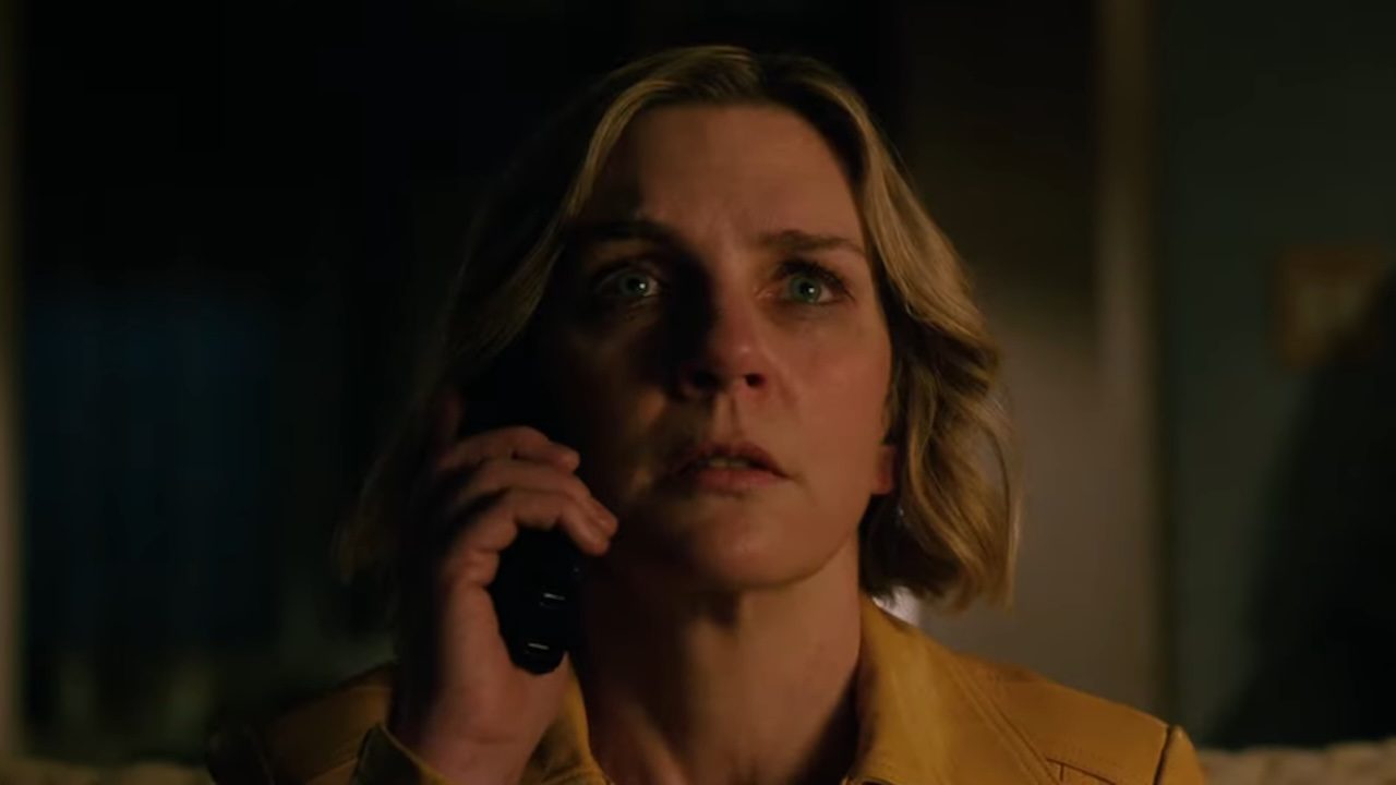 Rhea Seehorn holding a phone to her ear as Carol in Pluribus.