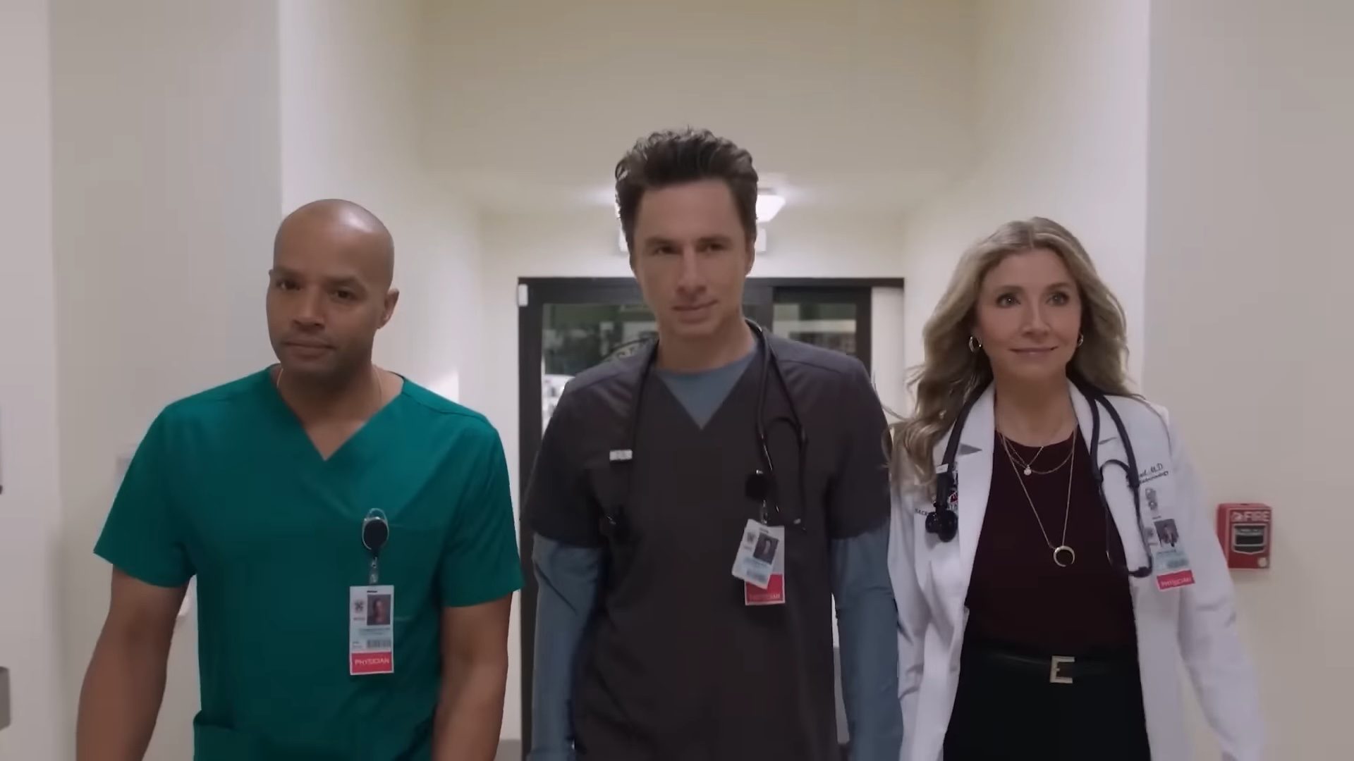 Three doctors walking down a hall looking cool in Scrubs.