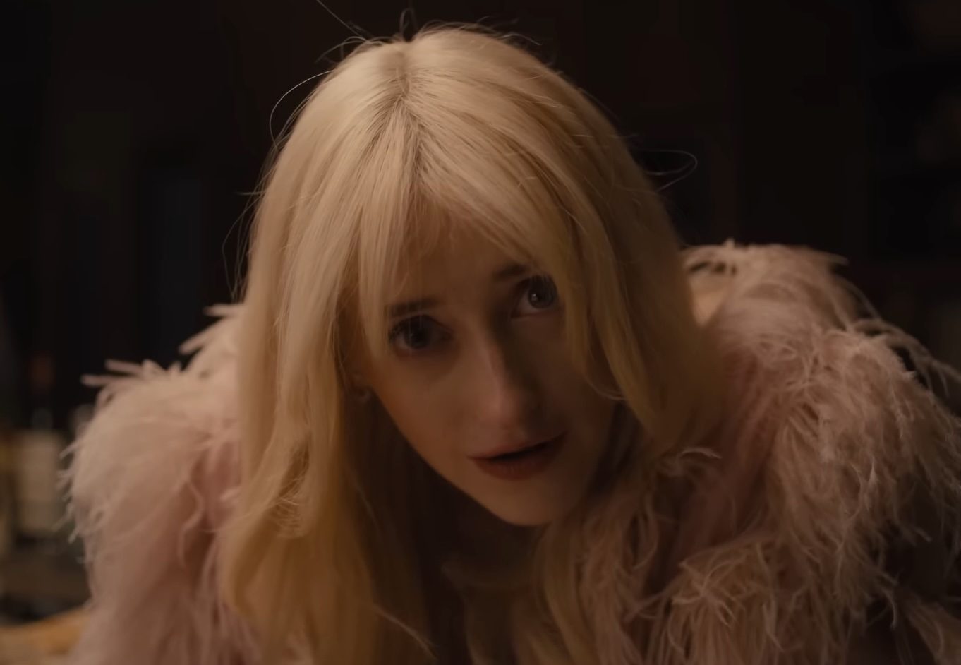 A woman smiling creepily at the camera in the Netflix series, Something Very Bad Is Going to Happen.