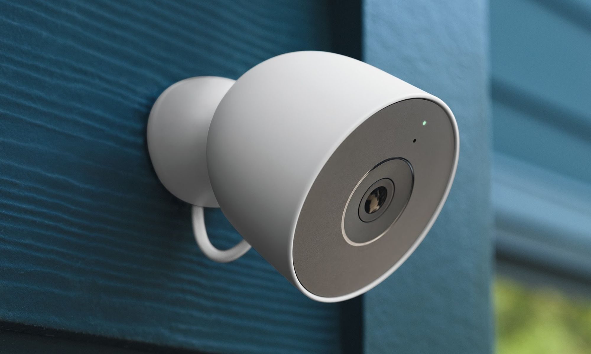 Google Nest Cam Outdoor wired installed on a blue wall