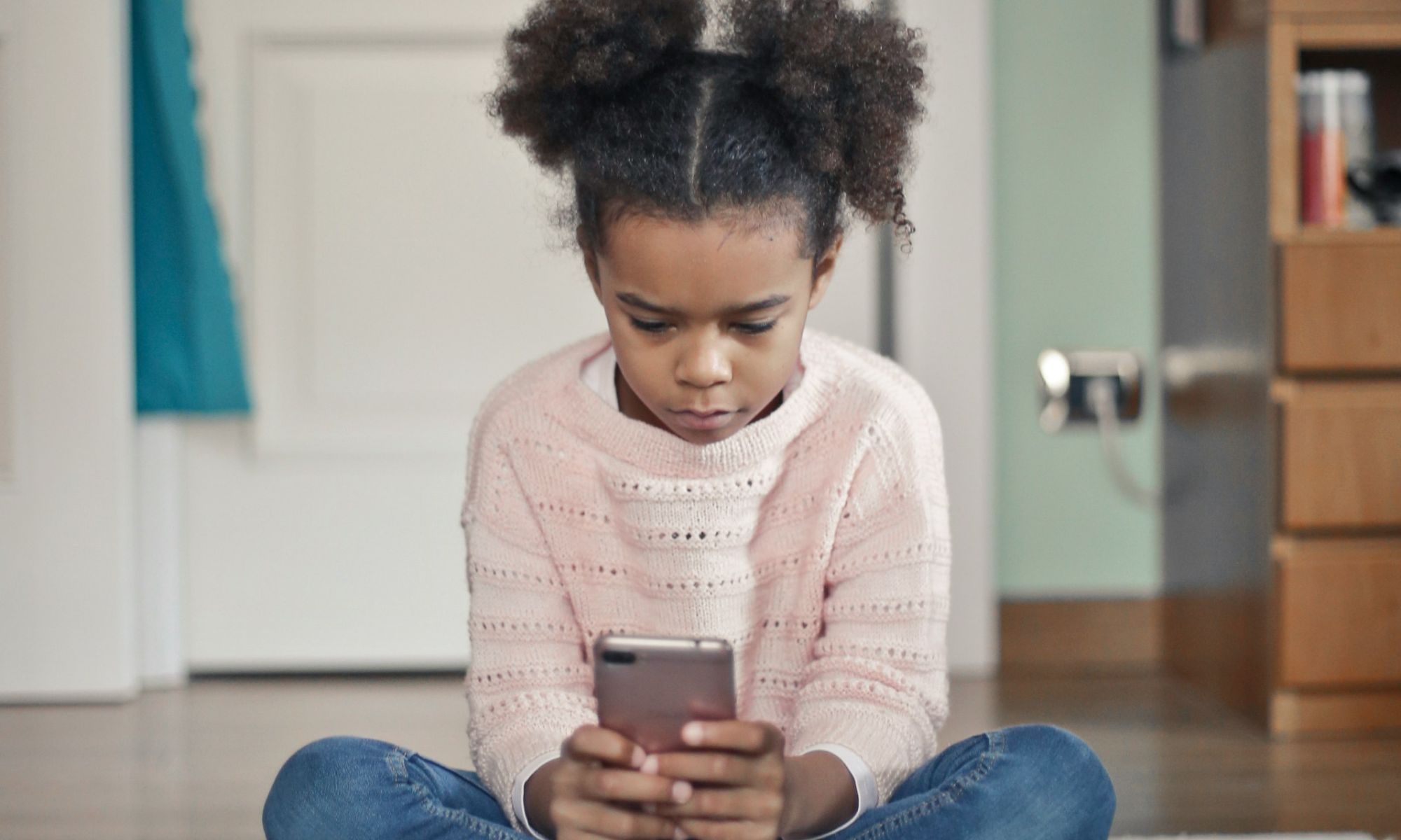 A young girl using a phone
