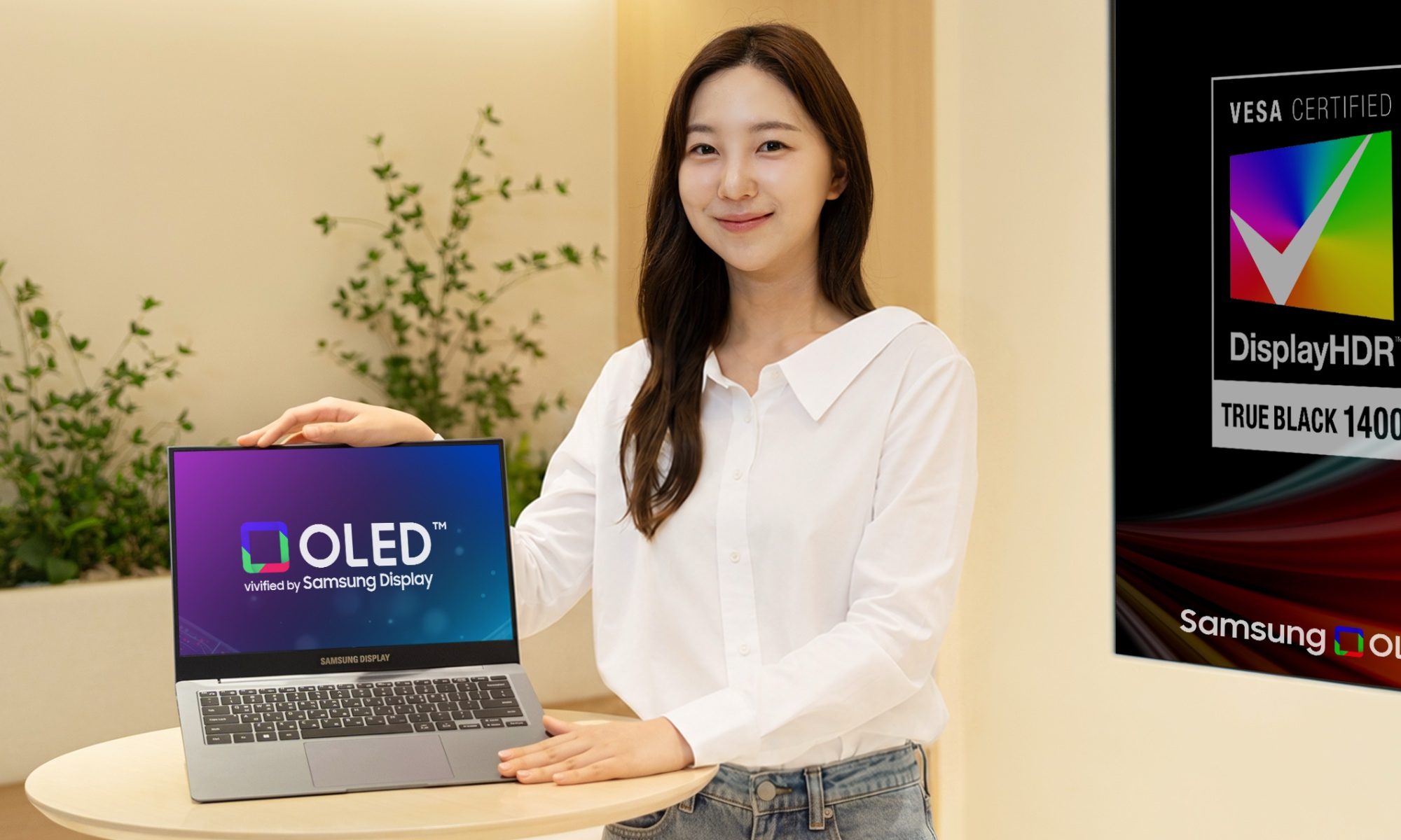 Girl showing new laptop tandem oled by Samsung Display