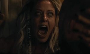 Katherine Isabelle screaming with white eyes in the horror film, Lockbox.