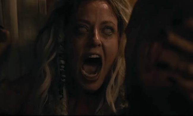 Katherine Isabelle screaming with white eyes in the horror film, Lockbox.