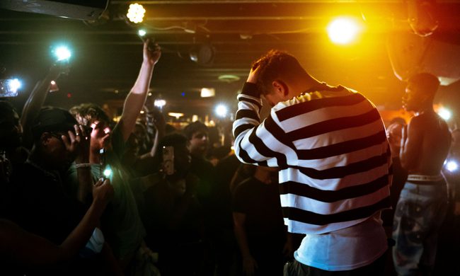 People pointing cameras at a person in a club