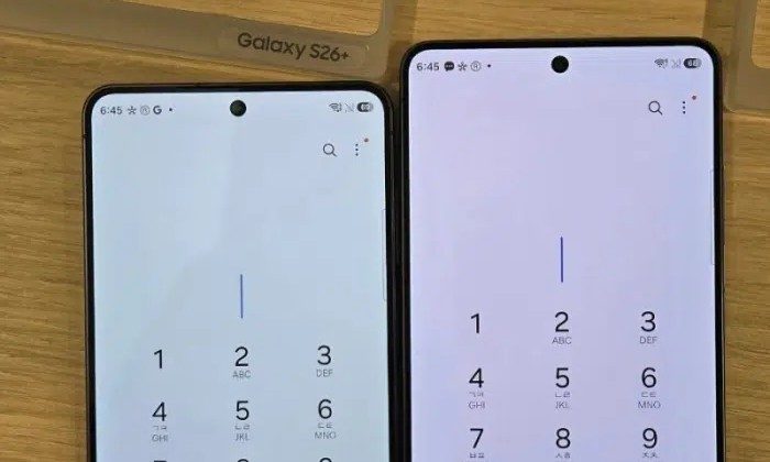 Samsung Galaxy S26+ next to a Galaxy S26 Ultra with reddish hue on its screen.