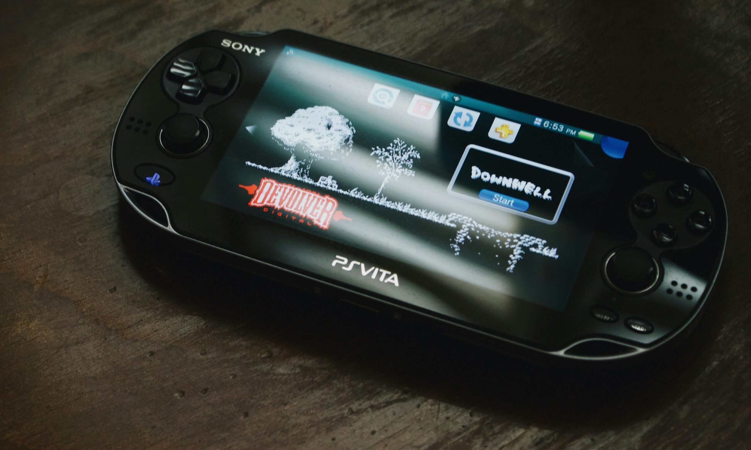 Sony PS Vita console on a wooden surface