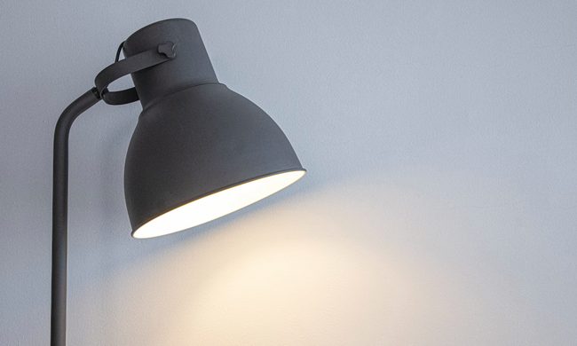 desk lamp with white wall behind it