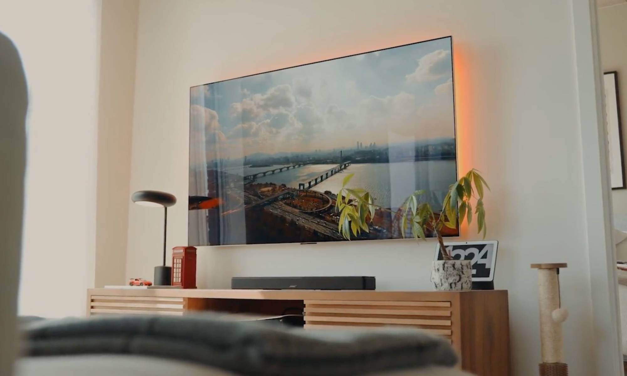 Bose Smart Soundbar placed under a TV on a wooden cabinet