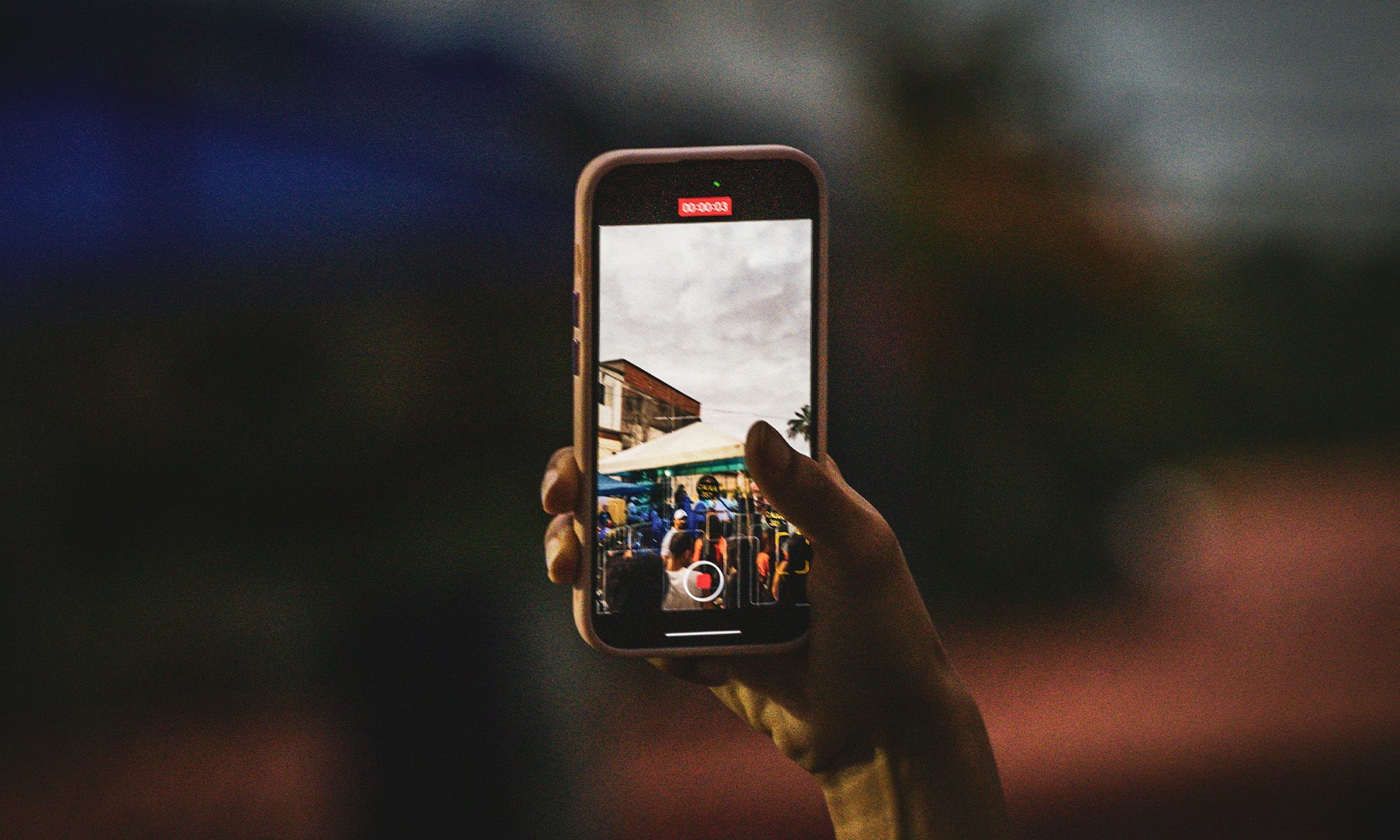Man recording video on iPhone
