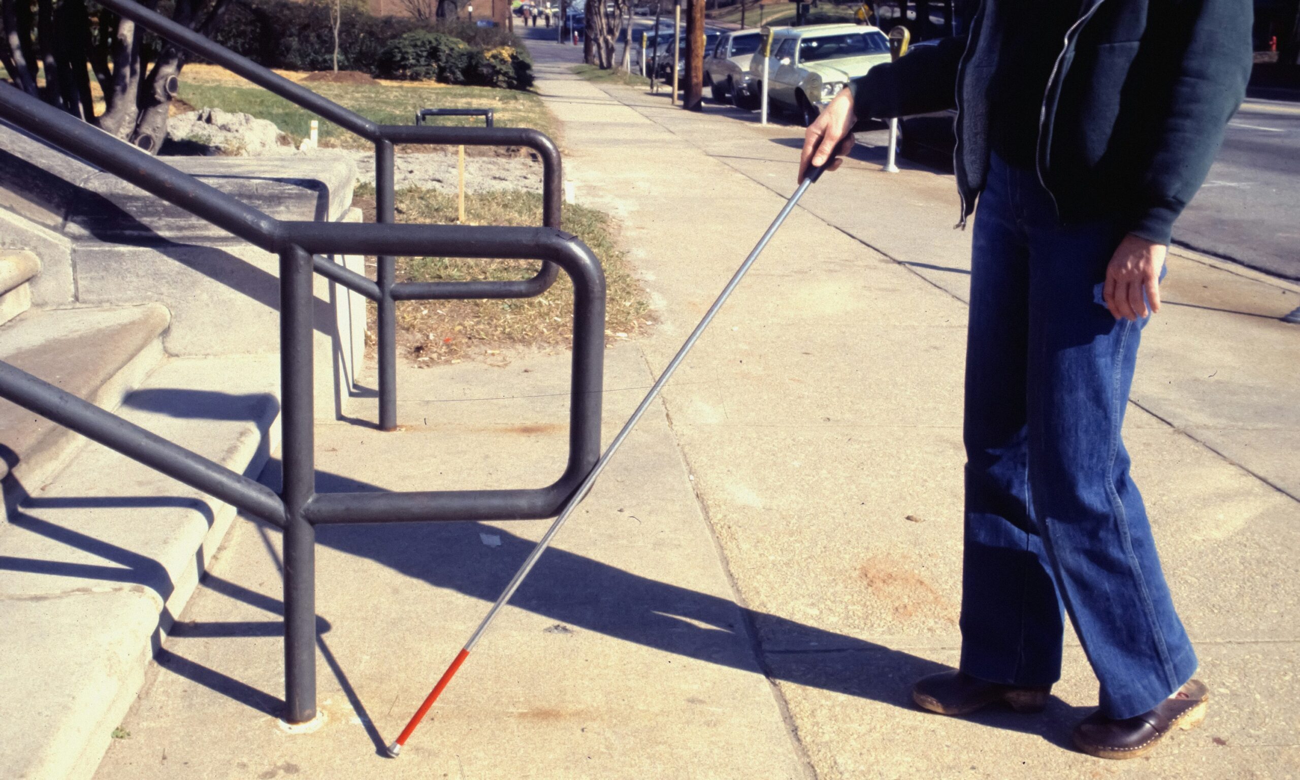 Visually impared person walikin on the Sidewalk