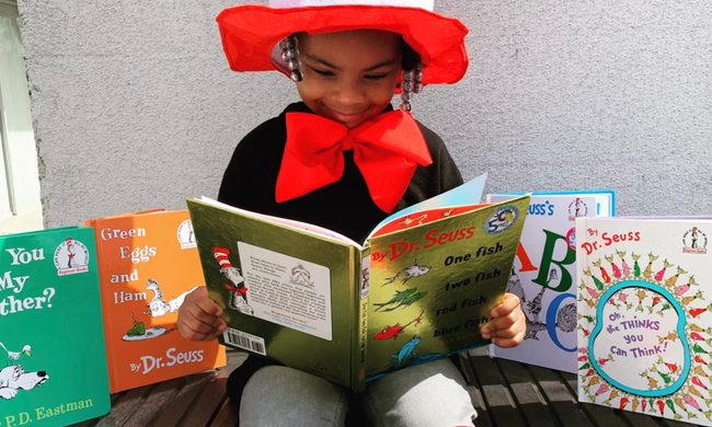 A kid reading a book.