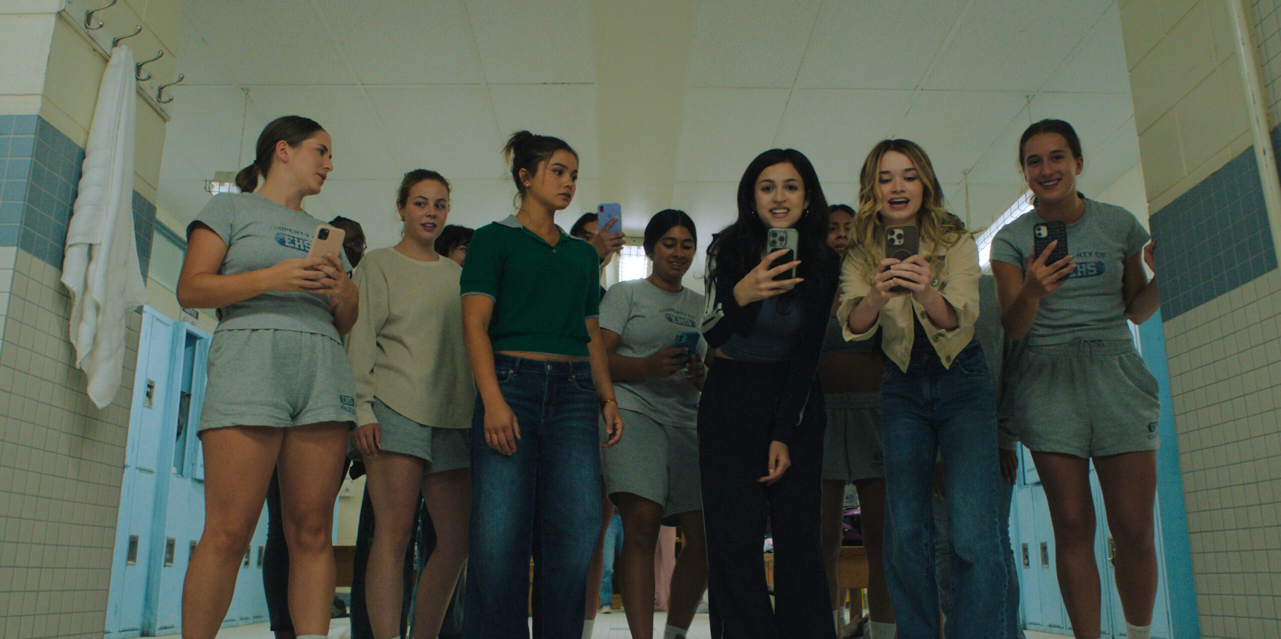 The cast of Prime Video's Carrie using smartphones.