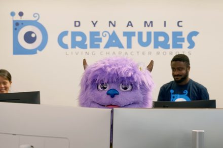 Hugo is fluffy, purple, and ready to steal your next theme park selfie. And oh! Hugo is a robot
