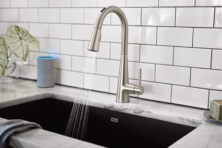The U by Moen smart faucet sprays water into a sink.