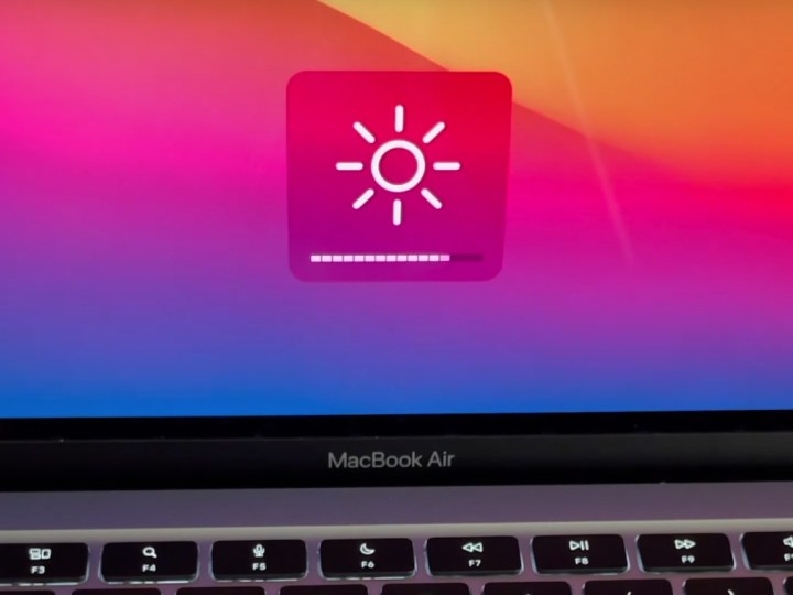 Fine tuning the brightness slider on a MacBook Air.