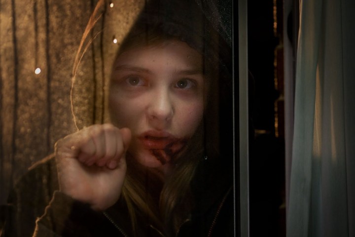 Chloe Grace Moretz knocks on a window in a scene from "Let Me In."