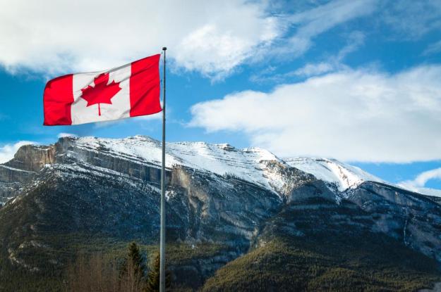 Canadian flag waving in the Rockies, from Shutterstock