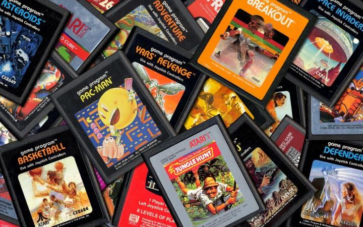 Atari cartridges sit in a pile.