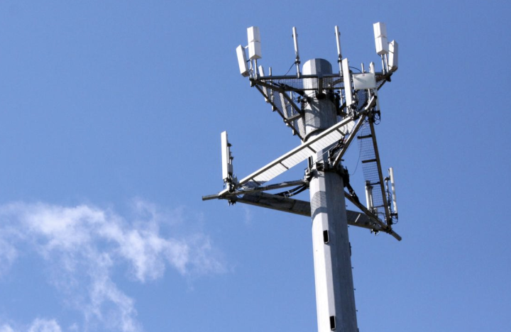 4G/5G cellular tower against blue sky.