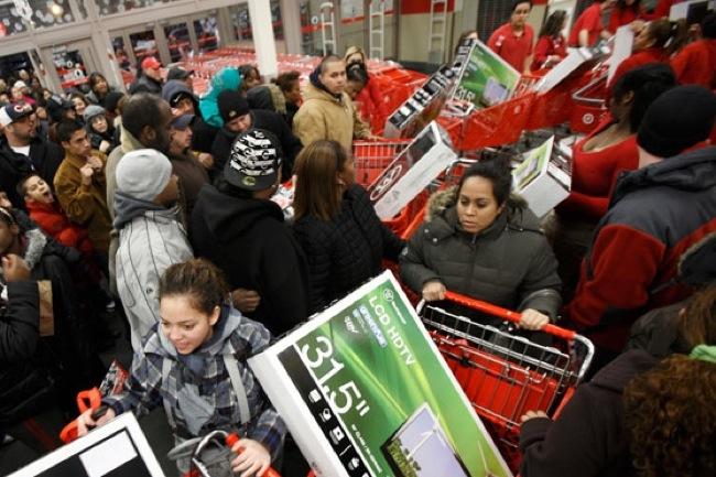 A Black Friday shopping mob with TVs in shopping carts.