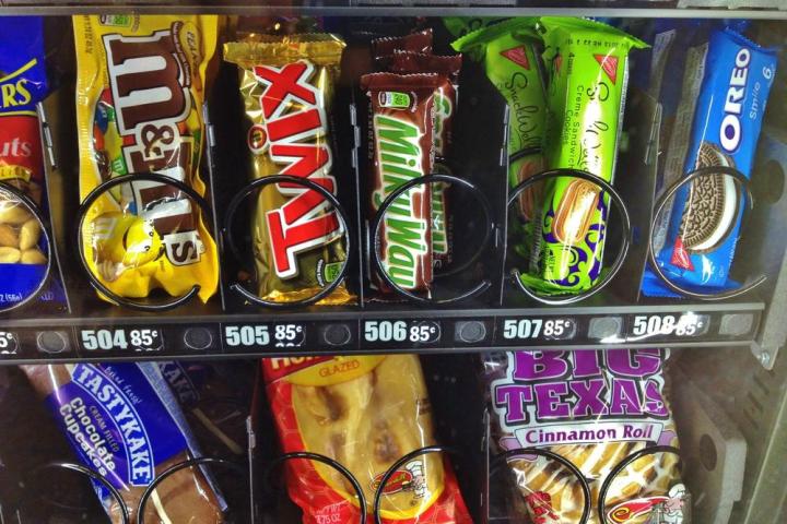 man uses forklift to dislodge twix bar from vending machine