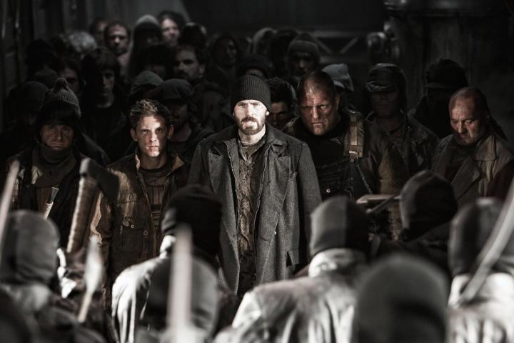 Jamie Bell, Chris Evans, and other cast members standing in Snowpiercer (2013)