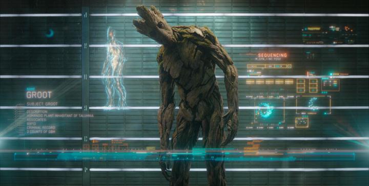 Groot bending and looking curiously at the camera in Guardians of the Galaxy.