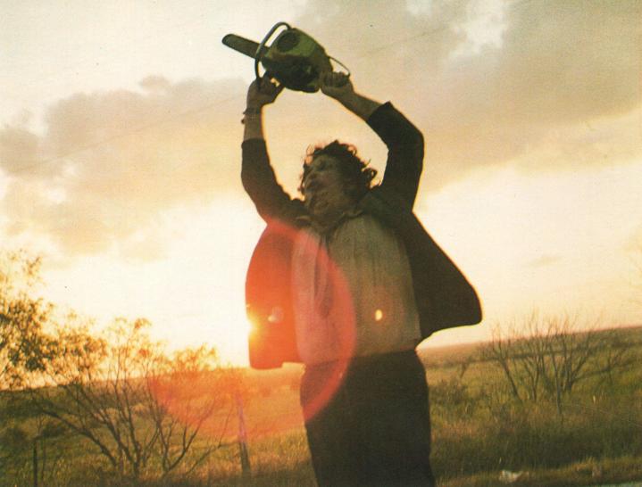 Leatherface wielding.a chainsaw in a field on Texas Chainsaw Massacre. 