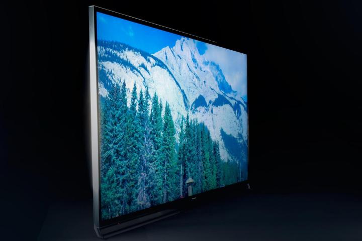 A view on an angle of a Panasonic TC-65AX800U TV showing a mountain scene. 