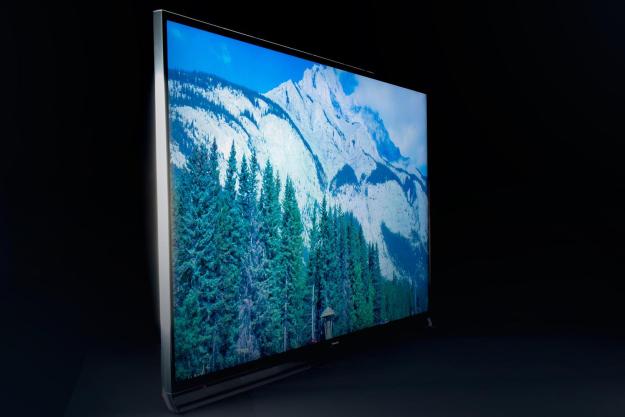 A view on an angle of a Panasonic TC-65AX800U TV showing a mountain scene.