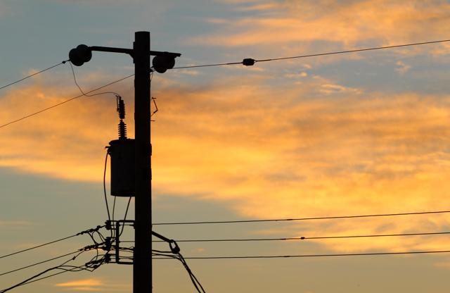 A telephone pole at dawn.