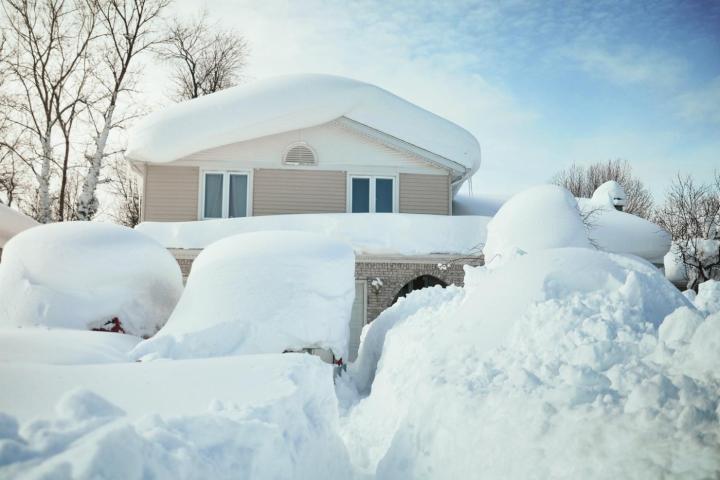 House buried in snow by blizzard.