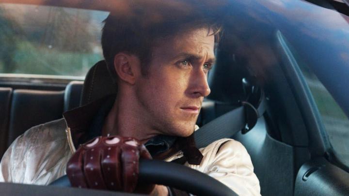 Ryan Gosling sits behind the steering wheel in Drive.
