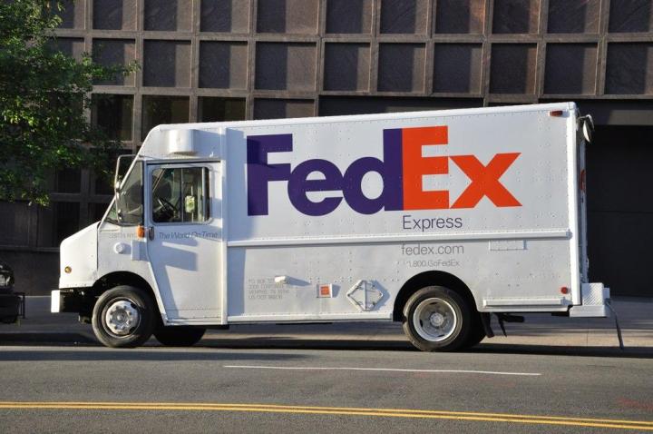 FedEx Van delivering shipments on a city street.