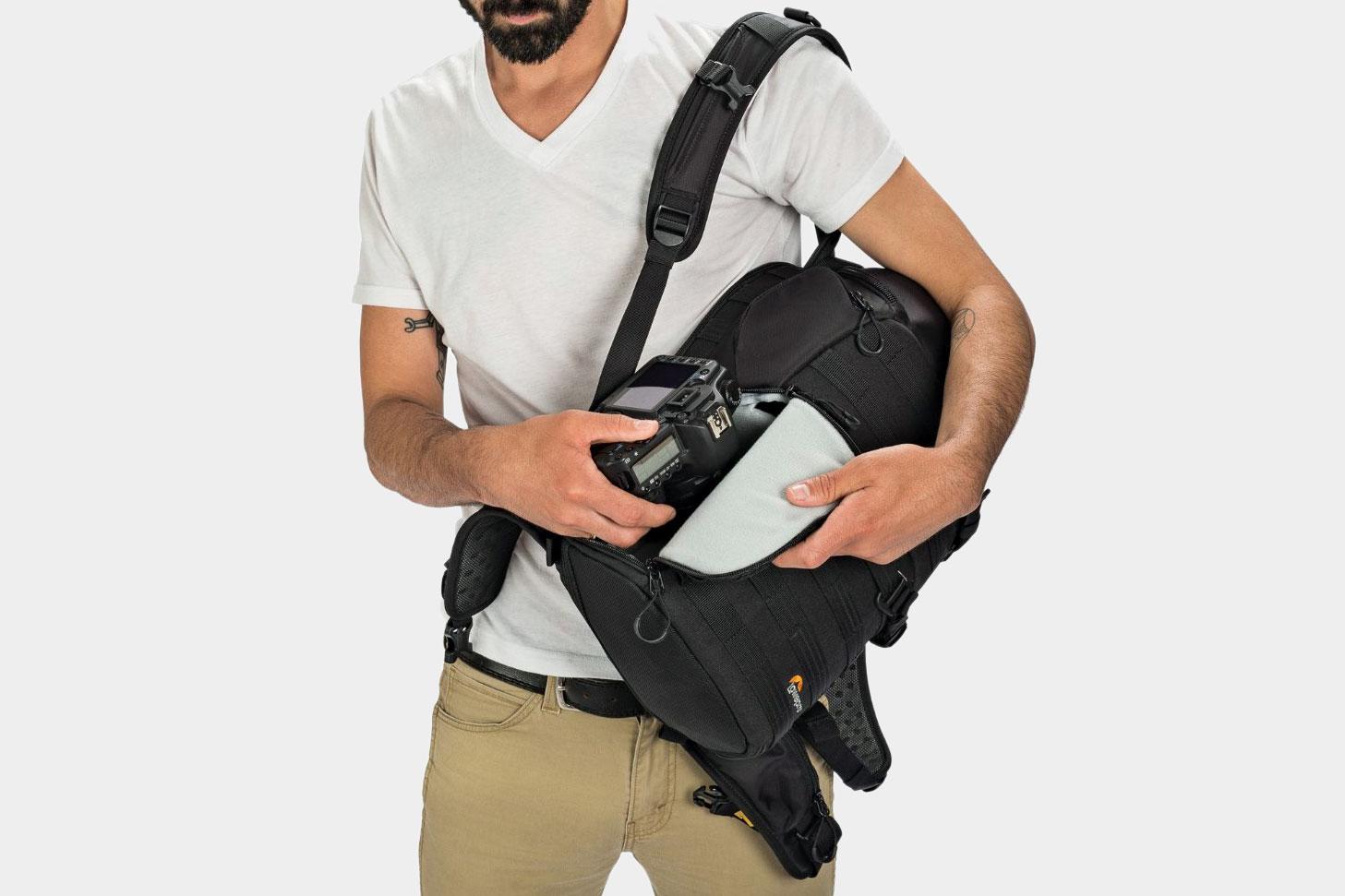 A person opening and using a Lowepro ProTactic 350 AW Camera and Laptop Backpack.