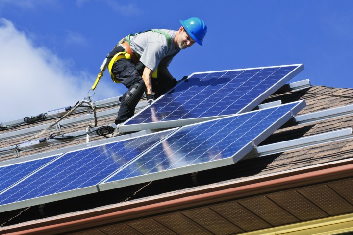 solarcitys rooftop solar panels are the worlds most efficient man installing on roof