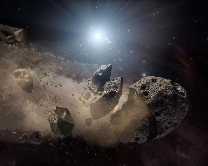 an illustration of an asteroid breaking apart in space
