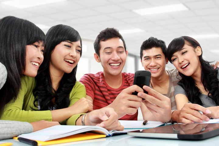 College students using smartphones.