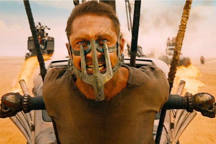 Tom Hardy strapped to the front of a vehicle in Mad Max: Fury Road.